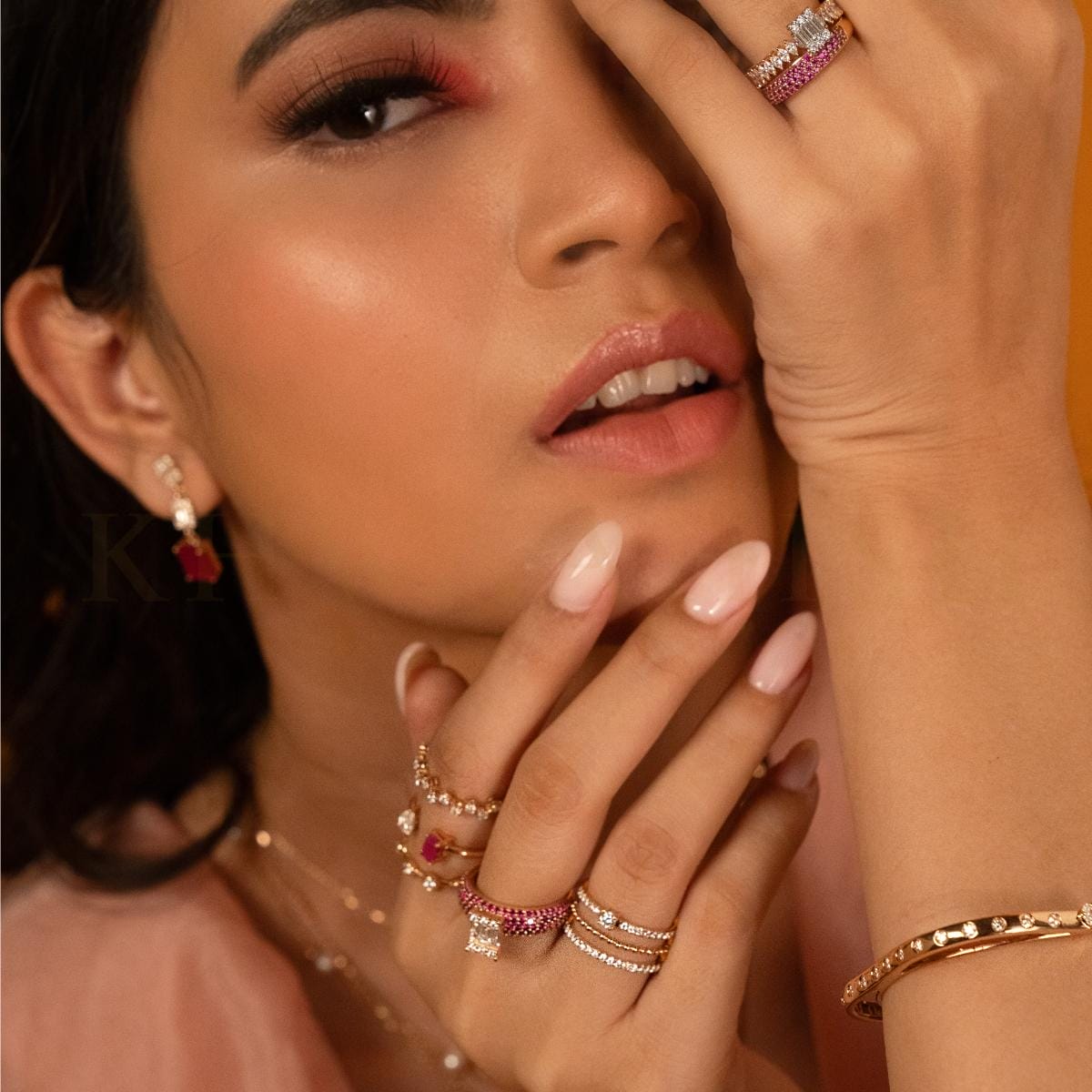 A modern woman poses with trendy rings studded with diamonds and colorful gemstones from the Gulz collection of Khwaahish.