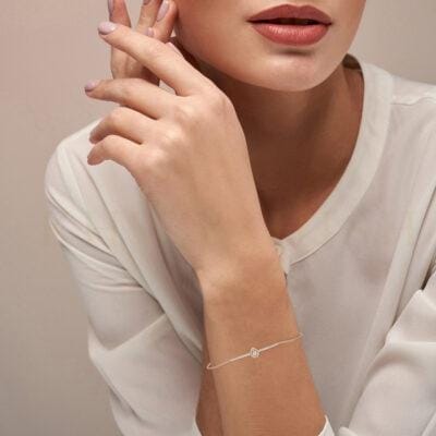 Close-up view of a model wearing Precious Petal Diamond Chain Bracelet in rose gold.