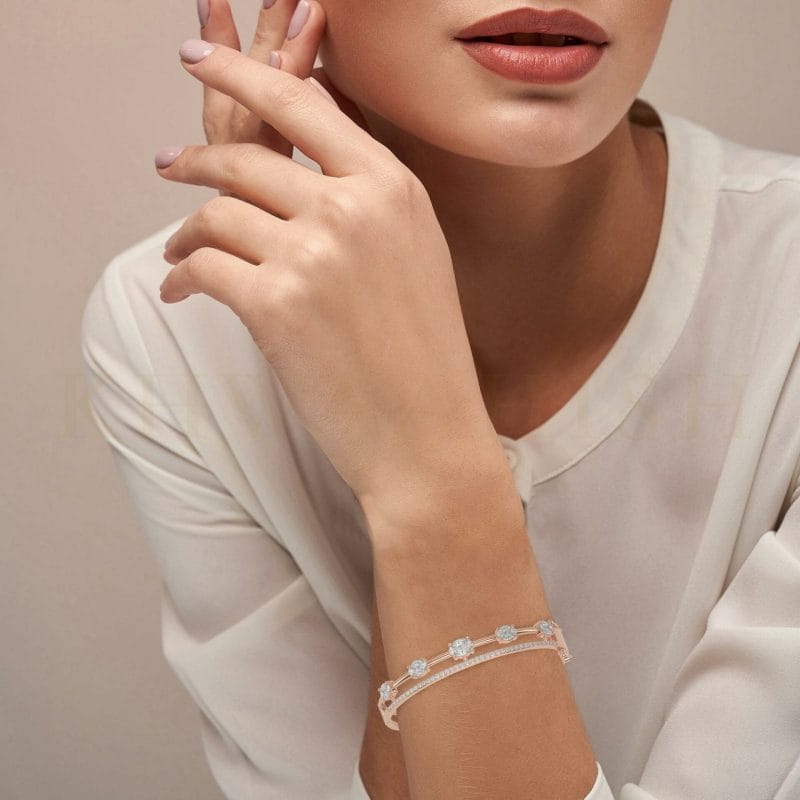 Close-up view of a model wearing Adorable Circlets Oval Diamond Bracelet in rose gold.