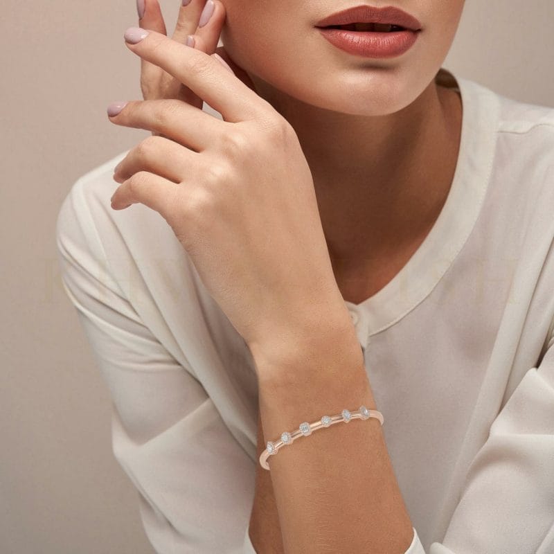 Close-up view of a model wearing Dainty Foliole Oval Diamond Bracelet in rose gold.