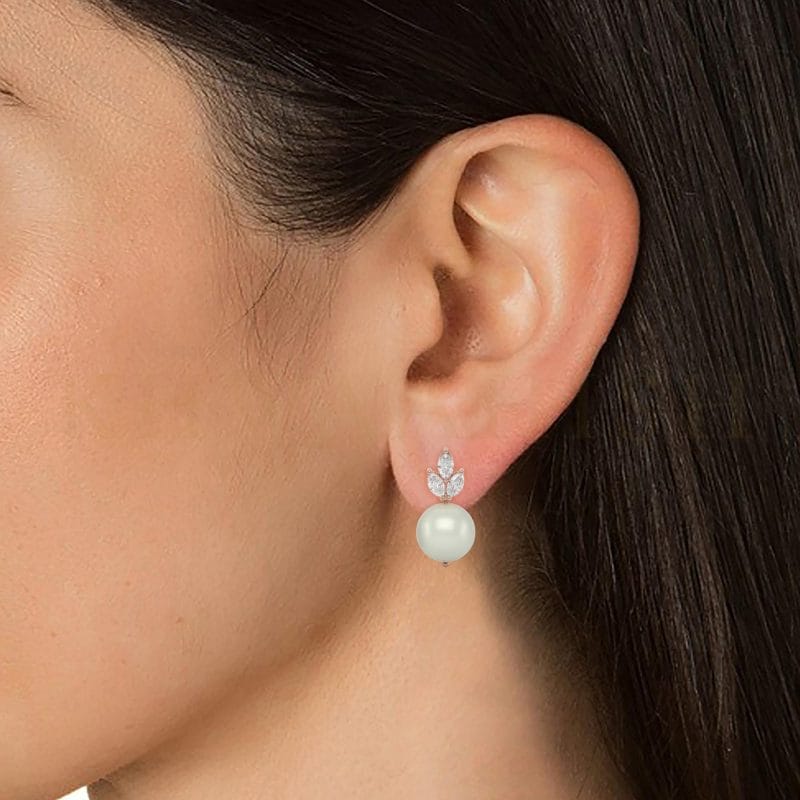 Close-up view of a model wearing Pretty Belle Diamond Drop Earrings in rose gold.