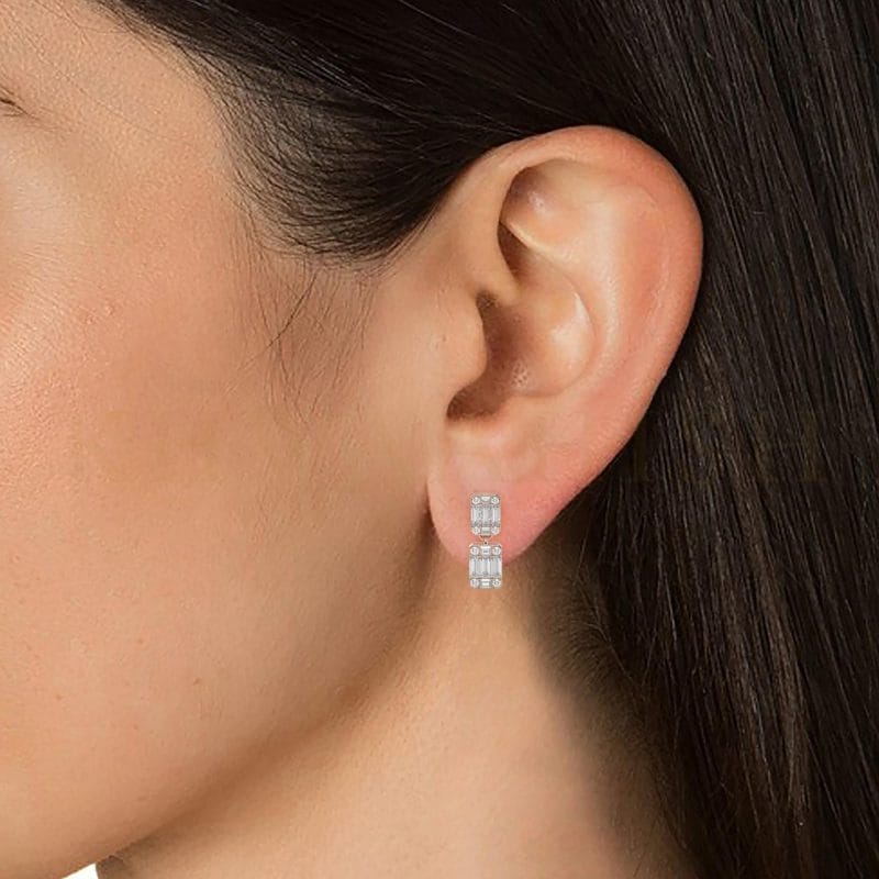 Close-up view of a model wearing Octogonal Opulence Diamond Drop Earrings in rose gold.