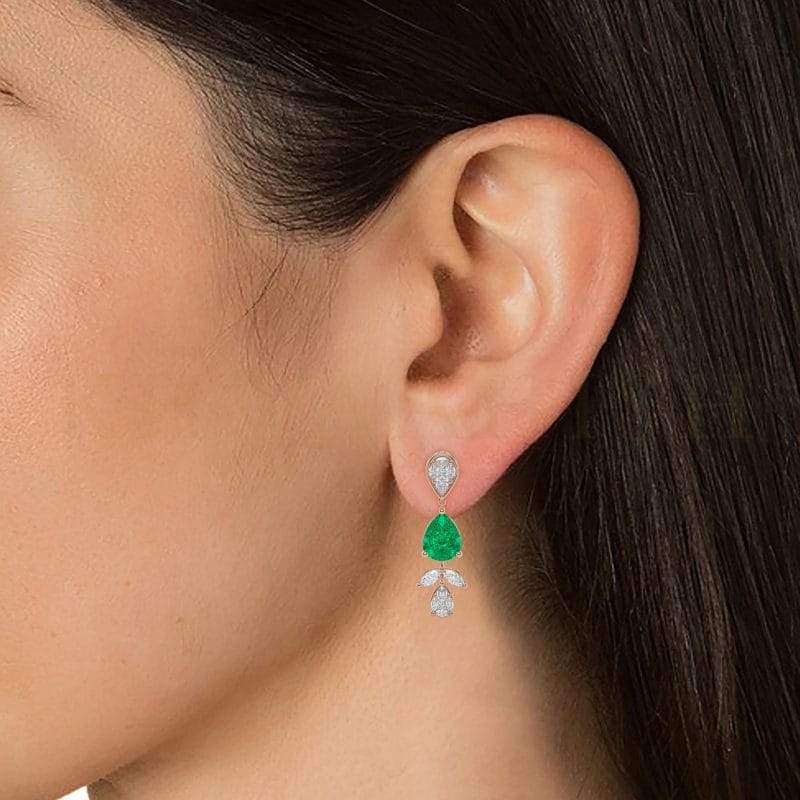 Close-up view of a model wearing Pear Pleasure Diamond Drop Earrings in rose gold.