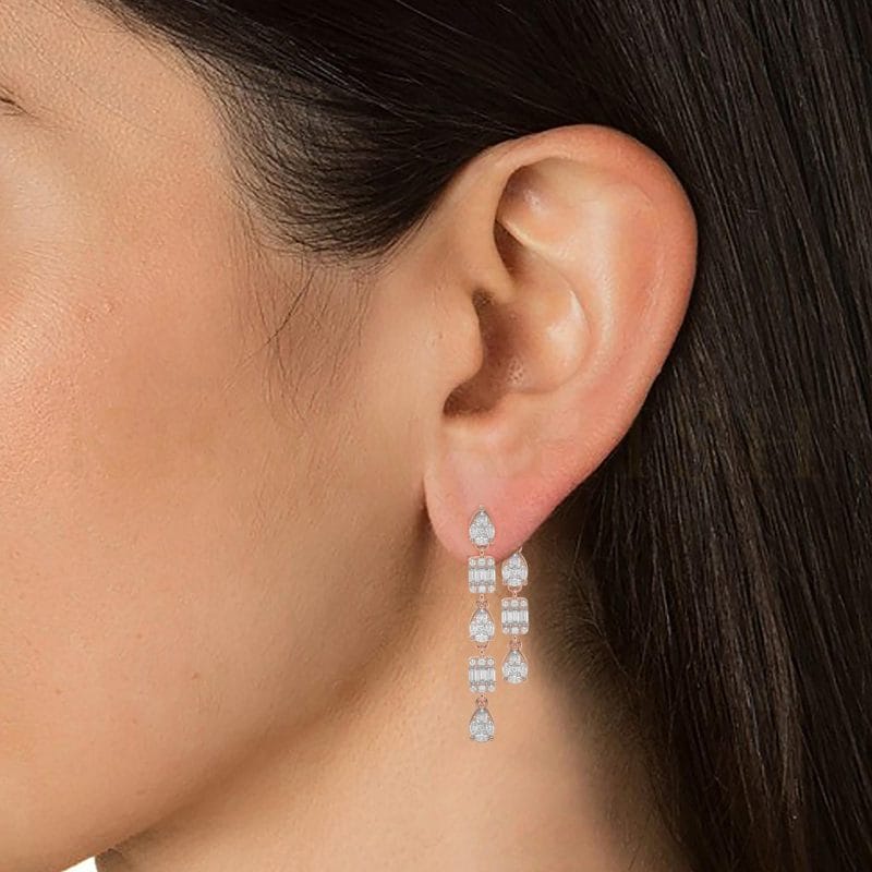 Close-up view of a model wearing Royal Grace Diamond Dangler Earrings in rose gold.