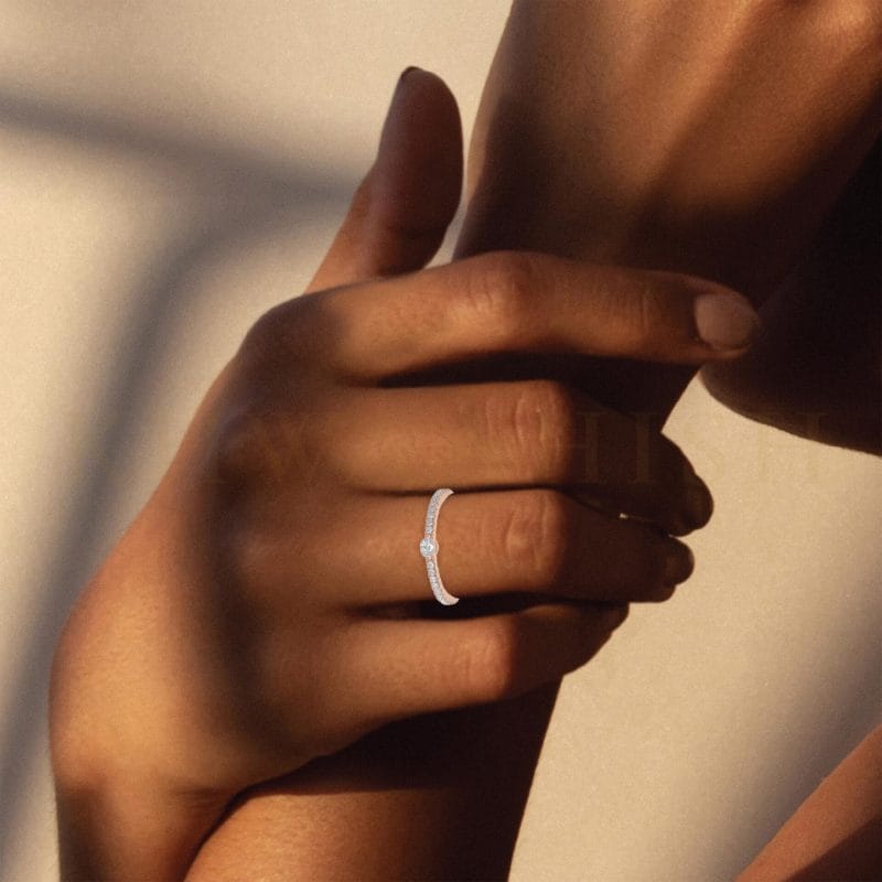 Close-up view of a model wearing Subdued Elegance Diamond Band Ring in rose gold.