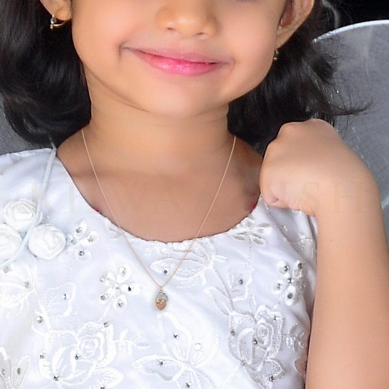 A small girl wearing the Sparkling Santa Diamond Kids Pendant in rose gold.